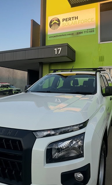 White vehicle parked outside of the Perth Solar Force office.